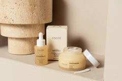 Hydrate & Glow bundle featuring the Super Vitamin C Serum and Daily Moisturizer against a sand-colored wall, highlighting a minimal and radiant skincare duo.