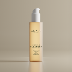 Hydrating Cleanser in a sleek glass bottle, displayed in a clear, sand-colored space, highlighting its minimal and refreshing skincare design.
