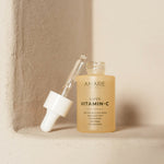 Anare Naturals Super Vitamin C Serum bottle placed in the corner of a brown aesthetic wall.