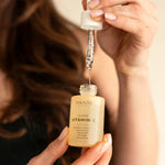 Model with brown hair demonstrating Anare Naturals Super Vitamin C Serum.